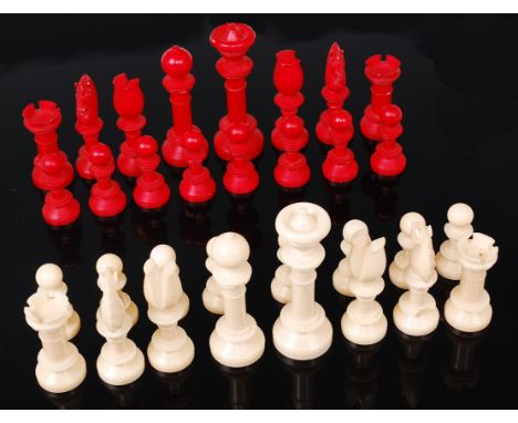 A turned ivory chess set, one side stained red, the other left natural, early 20th century, king h.8cm   Condition Report / E