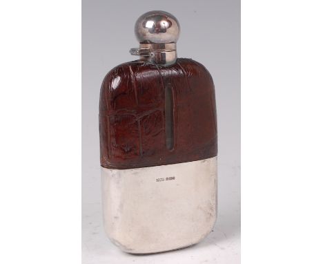 An Edwardian glass and silver hip flask, having hinged cap and monogrammed removable silver sleeve, maker James Dixon & Sons,