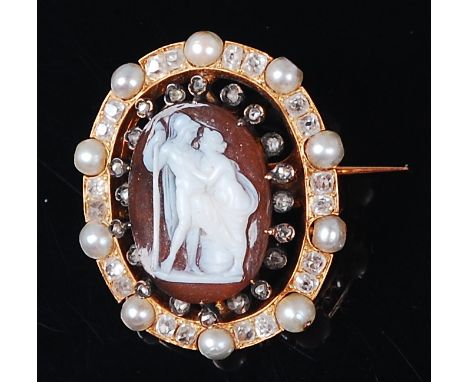 A circa 1900 carved shell cameo brooch, the classical figure scene within a surround of small rough cut diamonds and a furthe