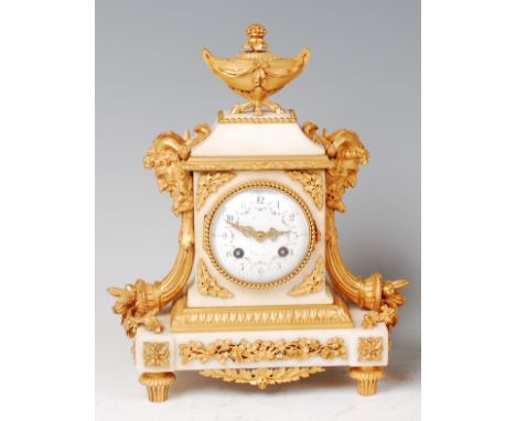 A 19th century French white marble and ormolu mantel clock, the whole surmounted with a classical urn, the case flanked to ei