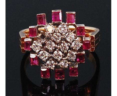 An 18ct gold, ruby and diamond set cocktail ring, arranged as fourteen small claw set brilliant cut diamonds (one stone missi