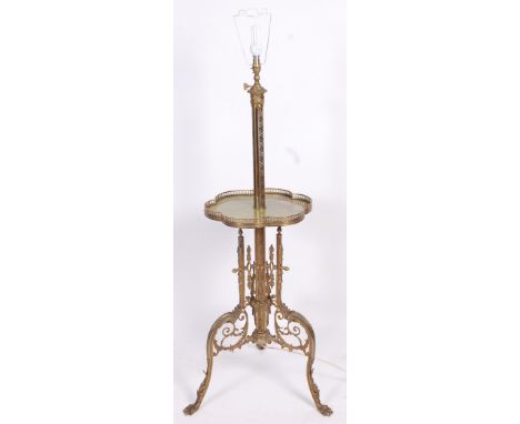 An Edwardian cast, pierced and engraved brass telescopic standard lamp, having a shaped onyx inset central platform over scro