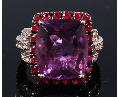 An 18ct white gold precious set dress ring, the centre four claw set antique cushion cut amethyst measuring approx 1.4 x 1.2 