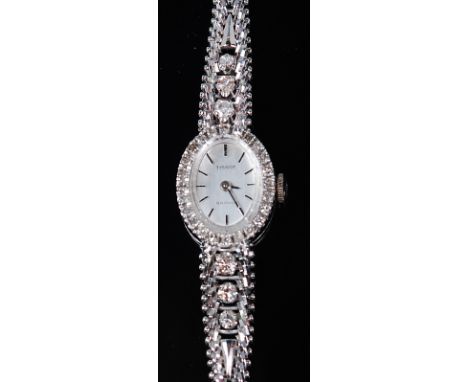 A ladies Tissot Saphir 18ct white gold and diamond set cocktail watch, having a signed oval silvered dial with a surround of 