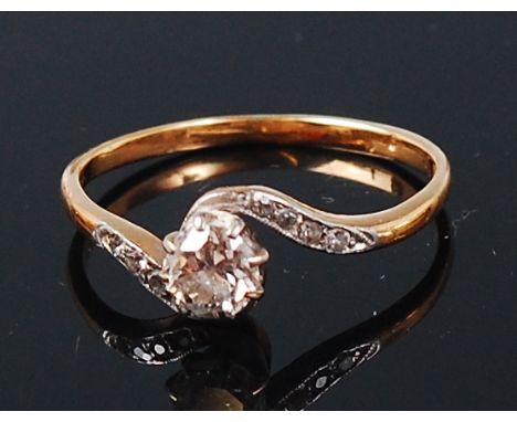 An 18ct gold and platinum diamond solitaire ring, the claw set old brilliant weighing approx 0.4ct, the shoulders each channe