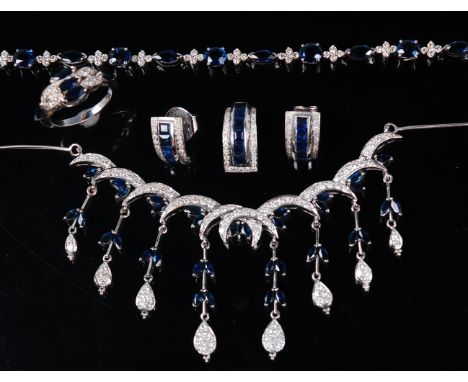 A contemporary 14ct white gold, sapphire and diamond set five piece garniture, comprising; necklet, pendant, pair of ear stud