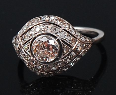 A white metal diamond cluster ring, the centre brilliant weighing approx 0.5ct, in a surround of two rows of small old cut di