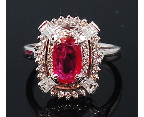 A contemporary 14ct white gold, ruby and diamond ring, arranged as a centre raised ruby weighing approx 1.64ct, in a two tier