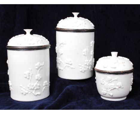 A pair of mid-18th century French Mennecy soft paste porcelain jars and covers with one other smaller example, in the style o