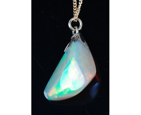 A polished opal pendant, the natural formed opal weighing approx 11ct and measuring approx 19 x 16 x 8mm, on 14ct gold fine c