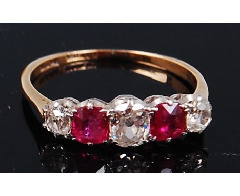 An early 20th century 18ct gold and platinum, ruby and diamond five stone ring, the centre old cut diamond weighing approx 0.