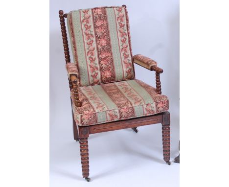 A Victorian walnut bobbin turned open armchair, having floral striped cushion upholstery, raised on bobbin turned forelegs an