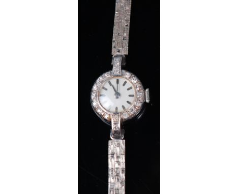 A ladies platinum and diamond set cocktail watch, having an unsigned white enamel dial within a surround of small brilliants,