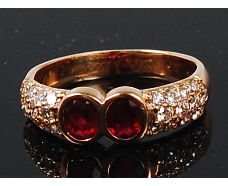 An 18ct gold, ruby and diamond ring, by Gubelin of Switzerland, the two oval cut rubies each weighing approx 0.25ct, the shou