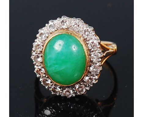 An 18ct gold chrysoprase and diamond set cluster ring, the cabochon chrysoprase measuring approx 11 x 9mm in a surround of sm