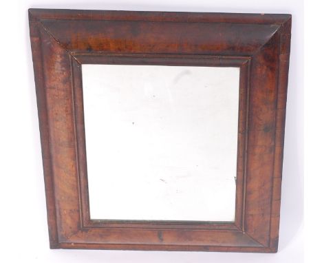 An antique walnut veneered cushion framed wall mirror, early 18th century with alterations, having later mirrorplate, 63 x 57