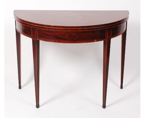 A George III mahogany and crossbanded demi-lune card table, the fold-over top on double rear gatelegs, the whole on square ta