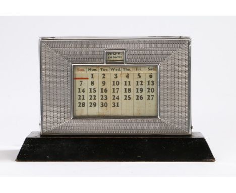 George V silver mounted desk calendar, Birmingham 1934, maker W J Myatt &amp; Co, the engine turned front panel above a plint