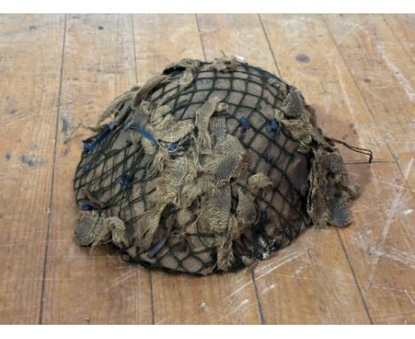Post war British steel helmet in camouflage hessian and netting