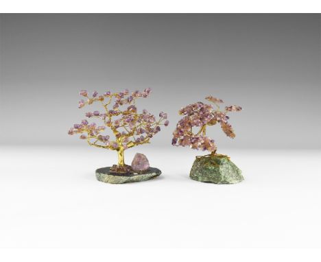 A group of two medium size gemstone trees consisting of a brass trunk and one with branches tipped with polished amethysts mo