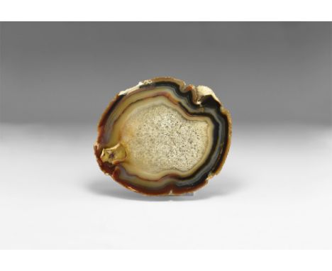 An unusual sawn and agate nodule with vari-coloured agate bands, the center completely filled with quartz crystals creating m