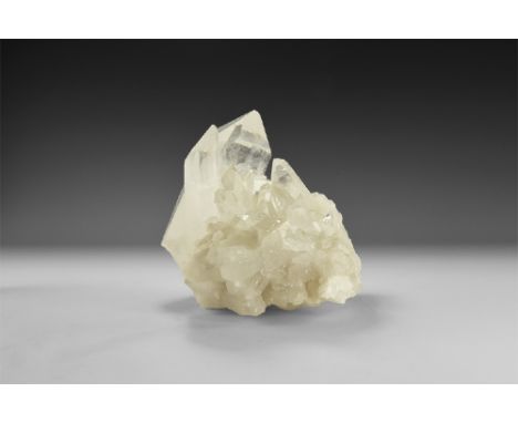An unusually fine cluster of quartz crystals with numerous well-formed and transparent crystals, one massive crystal to the t