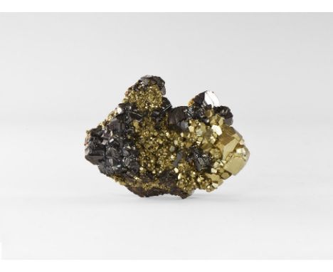 A specimen comprising a number of 'blackjack' (iron-rich) sphalerite crystals with highly lustrous faces resting on a bed of 