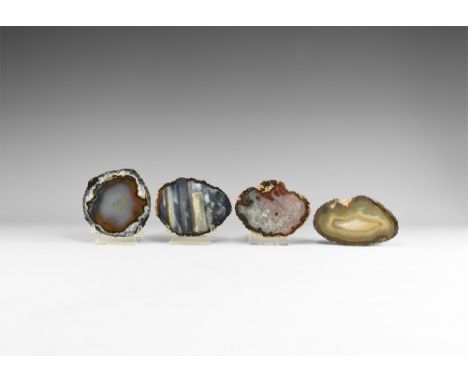 A group of four cut and polished agate nodule ends with bands of colour and crystalline growth. See Bonewitz, Dr. Ronald Loui