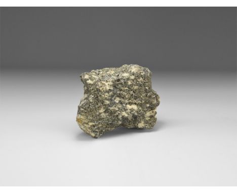 A large piece of Sutherlandshire nepheline syenite mineral with old Gregory Bottley & Co label reading: 'No. 27, Nepheline Sy