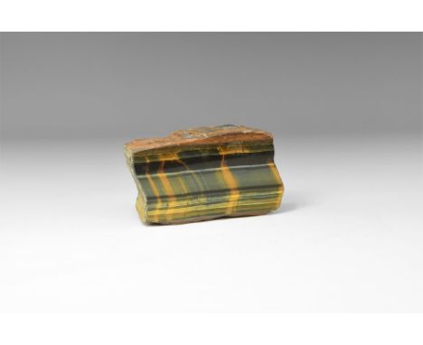 A large rectanglar cut and polished piece of tiger's eye with lustrous chatoyancy lines of green-blue with brown. See Bonewit