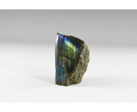 An exceedingly fine display specimen of labradorite, polished on one side, with blue, yellow, and green 'schiller' on the ent
