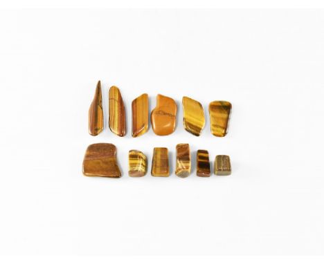 A group of twelve 'tumblestone' polished tigers eye slices showing silky lustre and bands of colour. See Bonewitz, Dr. Ronald