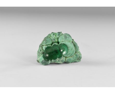 A nodule of malachite with lustrous sheen of pale and dark green, section cut from top showing internal structure. See Bonewi