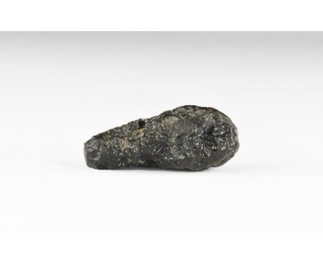 A teardrop-shaped piece of tektite meteoric glass, melted terrestrial rock splashed from an impact crater. See Bonewitz, Dr. 