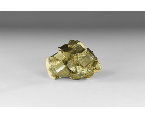A group of fine pyrite crystals on a matrix forming principally as large cubes modified by octahedrons, deeply striated, lust