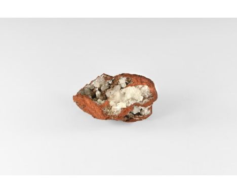 A large piece of pale red iron oxide matrix with hollows filled with hemimorphite crystals. See Bonewitz, Dr. Ronald Louis, R