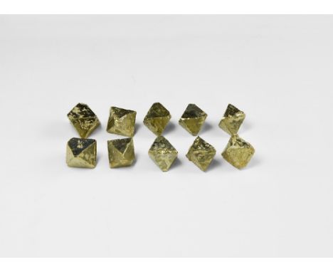A group of ten pyrite octahedron crystals with well formed facets and metallic lustre. See Bonewitz, Dr. Ronald Louis, Rocks 