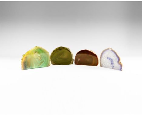 A four cut and polished agate geodes, one with brown and purple edges, body with honeycomb pattern of white crystals with pur