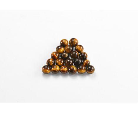 A group of twenty tigers eye spheres showing bands of black and brown silky lustre. See Bonewitz, Dr. Ronald Louis, Rocks & M