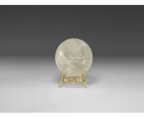 A sphere of rock crystal quartz with numerous internal features producing a rainbow effect, with stand. See Bonewitz, Dr. Ron