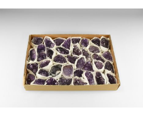 A box of thirty eight amethyst clusters, ranging in colour from a pale, almost transluscent purple to a deep rich purple; som