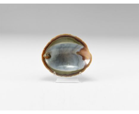 A cut and polished slice of agate formed into a bowl with blue-grey crystallisation and bands of yellow to the sides. See Bon