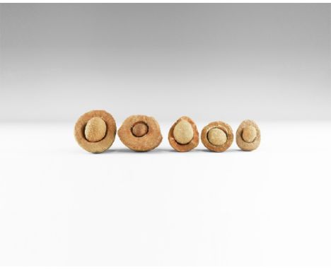 Group of five wind-rounded pebbles with their individual hollowed out 'nests', from the Kalahari Desert region, western Afric