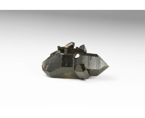 A fine double-terminated smoky quartz crystal with several smaller crystals growing attached. See Bonewitz, Dr. Ronald Louis,