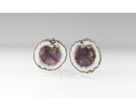A large geode with band of pale blue-grey agate border and clusters of amethyst crystals with inclusion to one side. See Bone