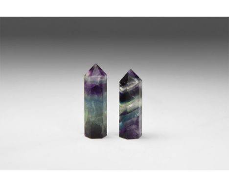 A pair of prism cut fluorite polished points with bands of colour ranging from jade green, purple and clear, with 'rainbow' r