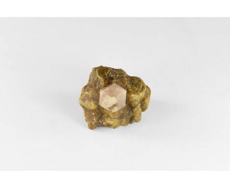 An unusual specimen of vesuvianite (formerly called idocrase) and pink grossular garnet, from Mexico, in white card tray with