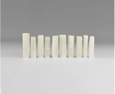 A group of ten satin spar gypsum columns, each with striated surfaces and chatoyant lustre. See Bonewitz, Dr. Ronald Louis, R