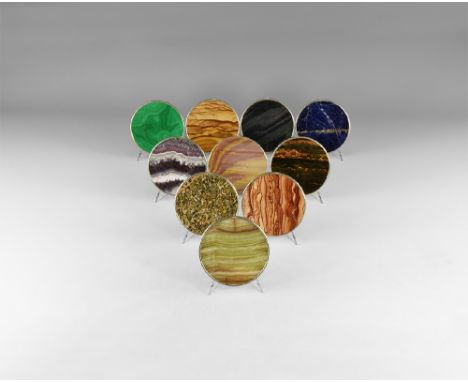 A group of ten cut and polished mineral disc coasters set in a gilt metal frame including: lapis lazuli, malachite, fluorite,