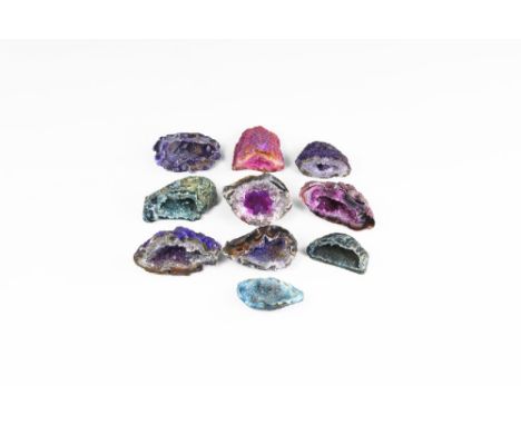 A group of ten cut and polished agate geodes of varying colours and with clusters of crystals in the central cavities; colour